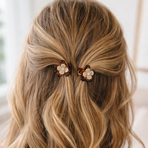 Blonde hair with wavy texture featuring decorative hair clips.