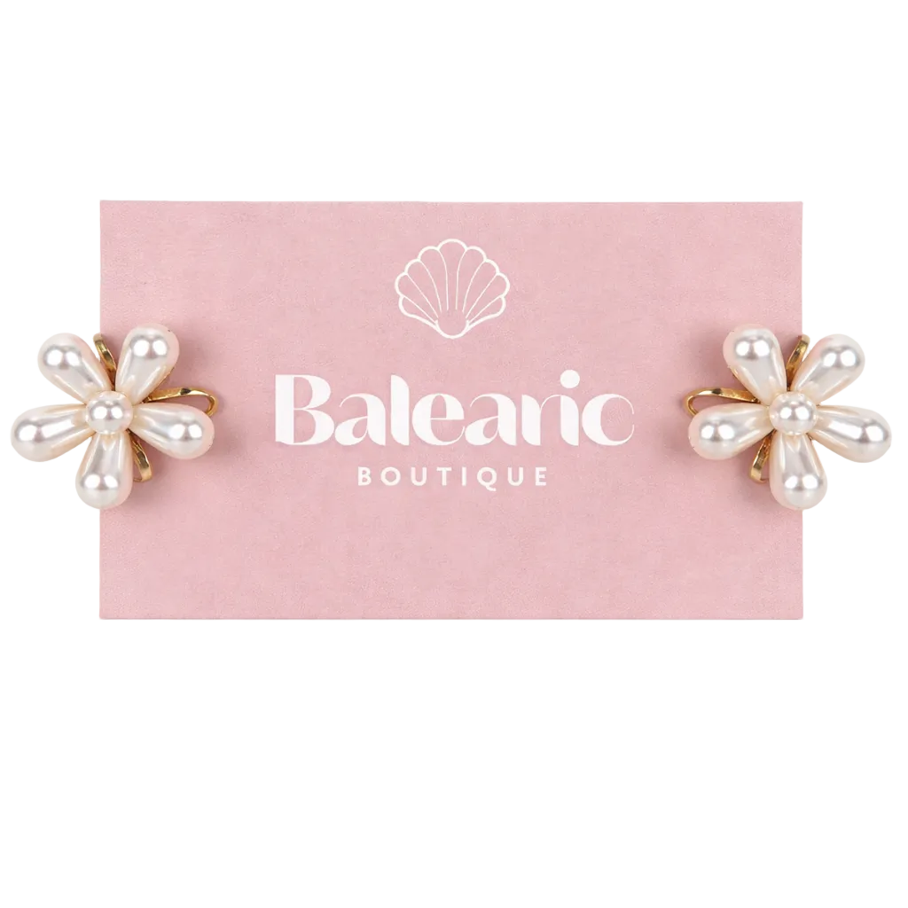 Pair of pearl flower earrings on a pink card with 'Balearic Boutique' branding.