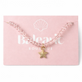 Necklace with a star charm on a pink card from Balaric Boutique