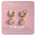 Pair of gold hoop earrings with shell charms on a pink card labeled 'Baleanic'.